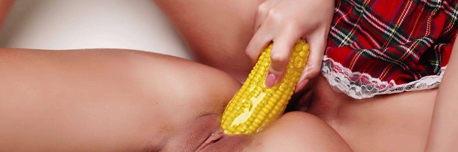 Girl uses corn as a dildo in other girls pussy